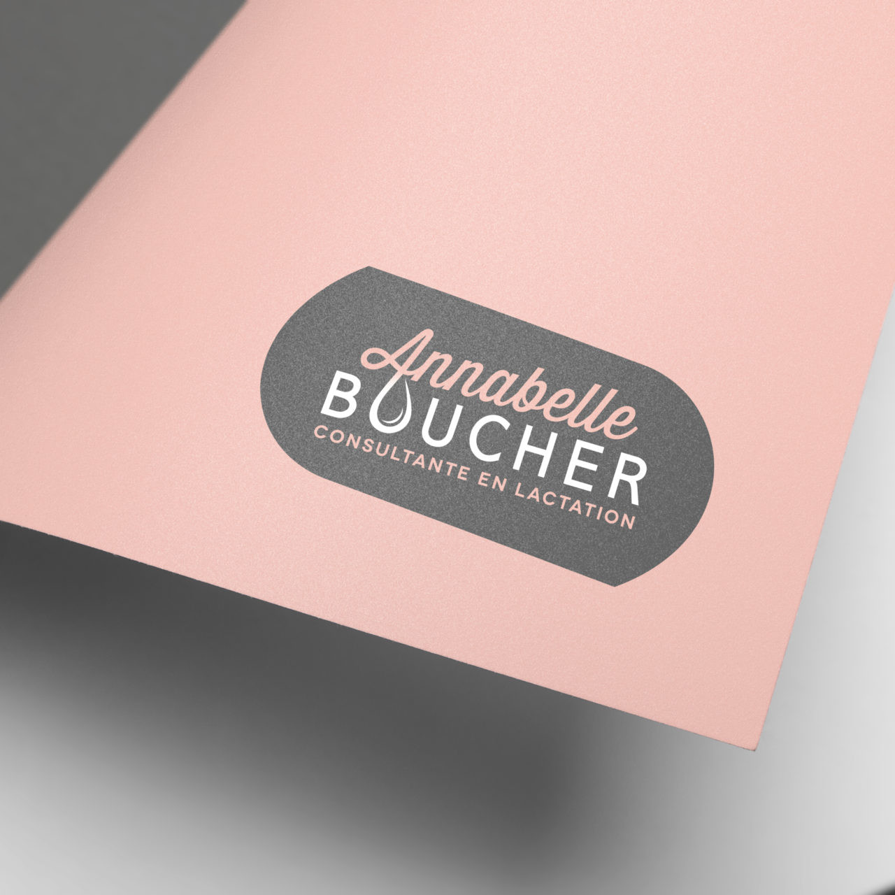 Rolled up white paper with pink back and Annabelle Boucher logo