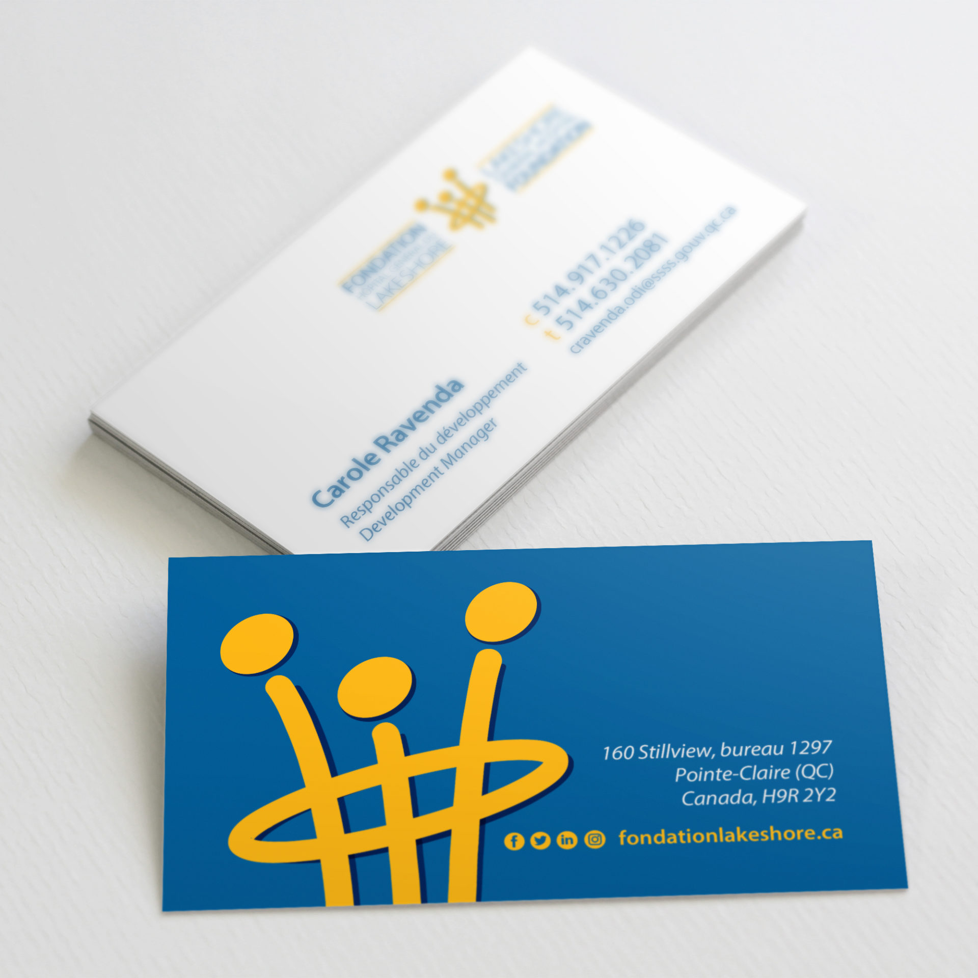 Front and back of business cards with blue background and yellow logo mark on one side and contact information on the other.