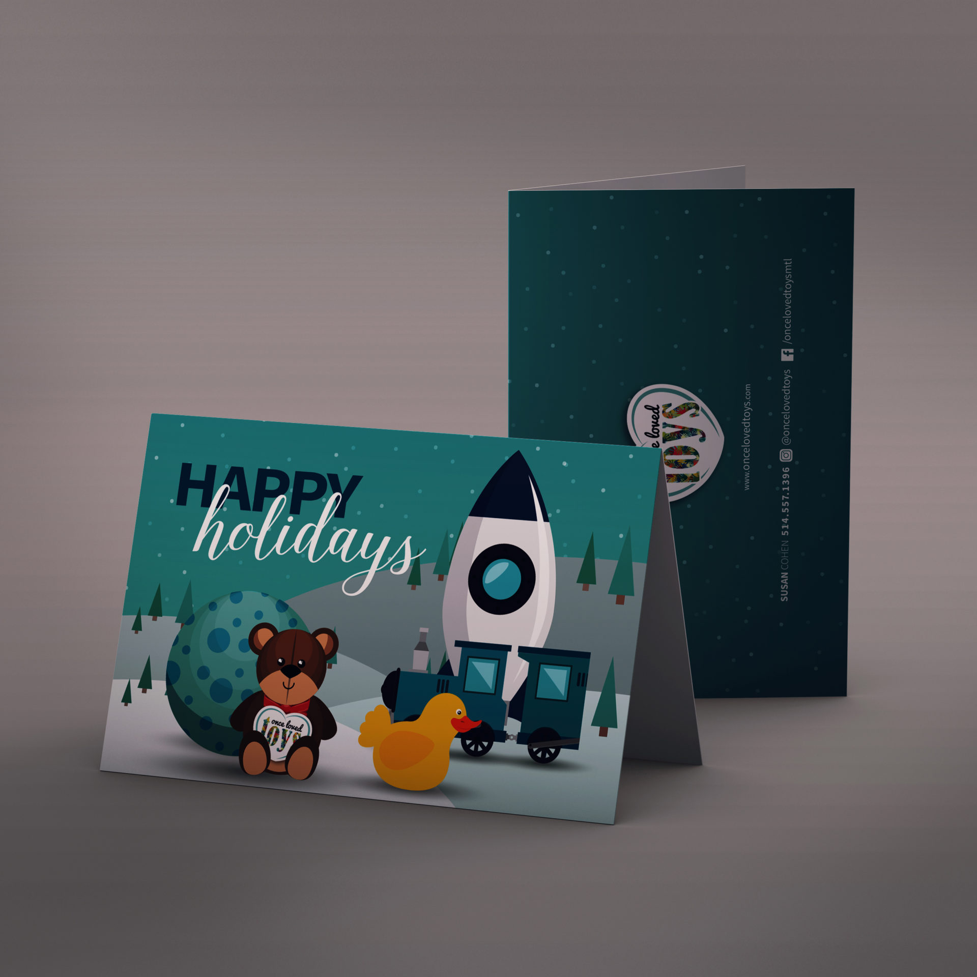Holiday greeting card with illustration of toys (Rubber ducky, stuffed animal, train cart) in the snow with the words 'Happy Holidays'.